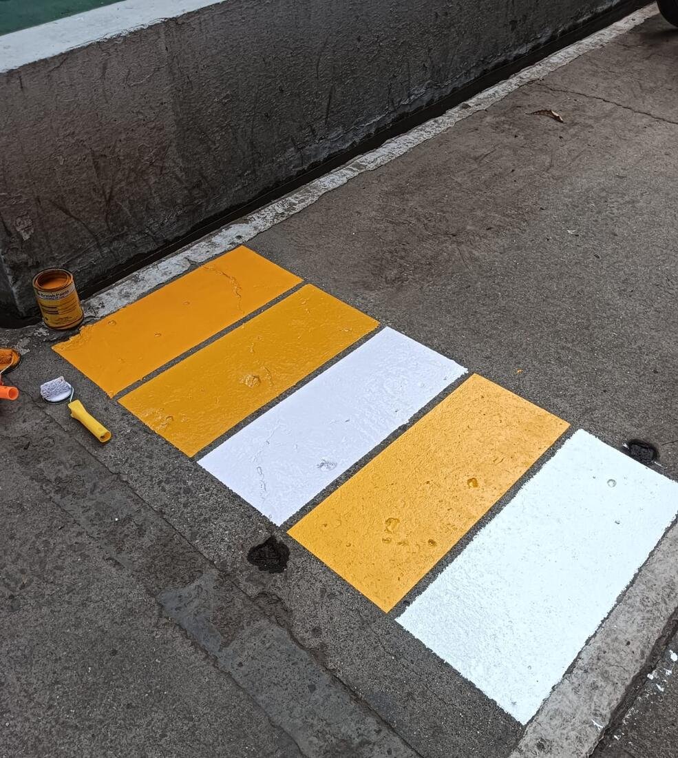 Yellow, white and orange parking curb and bumper painting